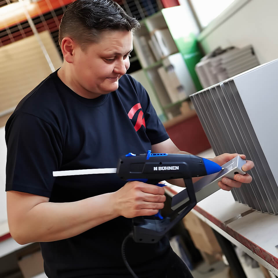 Arbeitsschritt in der Fertigung: Kartonteile werden von Hand verklebt